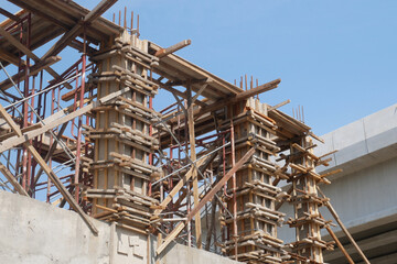 Fototapeta na wymiar PENANG, MALAYSIA -JUNE 3, 2021: Column timber formwork and reinforcement bar at the construction site. Installed by construction workers. The formwork supported by the temporary wood support.