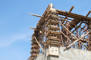 PENANG, MALAYSIA -JUNE 3, 2021: Column timber formwork and reinforcement bar at the construction site. Installed by construction workers. The formwork supported by the temporary wood support.