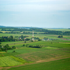 A cell tower near a village in a field