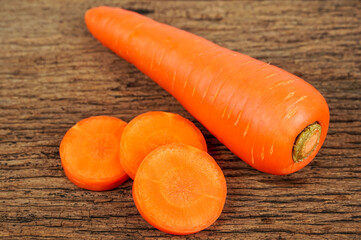  fresh carrots on wooden background.