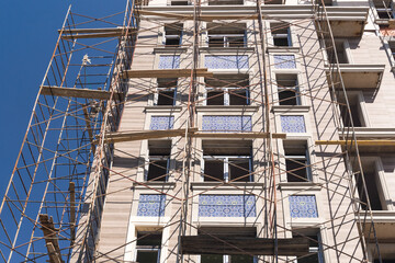 Fototapeta premium Finishing works on the facade of a new residential buildings
