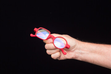 Glasses in the hand of a person