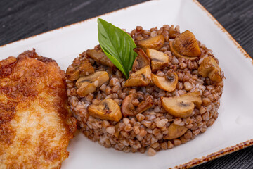 buckwheat with mushrooms and onions, served with greens