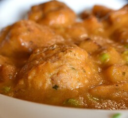 Macro detail of meatballs in garden sauce. Eat rich in a rural restaurant with local products.