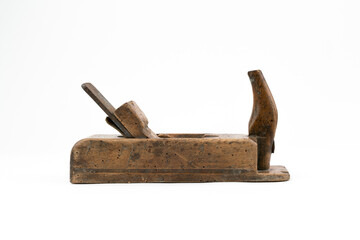 Horizontal low angle studio shot of small vintage wood planer isolated on white background. Old carpenter tool with wood worm holes in it. Carpentry concept. - obrazy, fototapety, plakaty