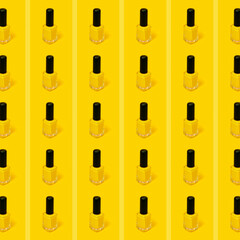 Pattern of yellow nail polish with yellow background