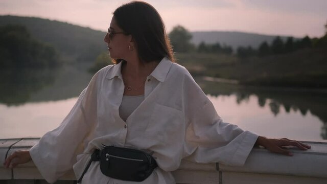 pretty woman is enjoying summer vacation, portrait at nature at sunset time