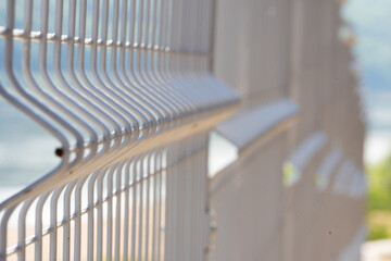 Metal vertical fence with a strong background blur, a territory free of COVID-19