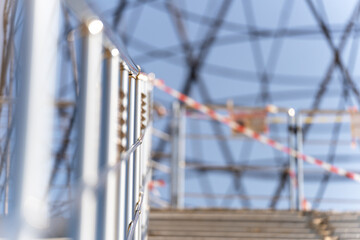 Staircase fence, metal, round, steps up, sun, background blurred, abstraction