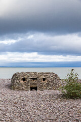 A old defensive pill box on the beach at Porlock Weir, Somerset UK