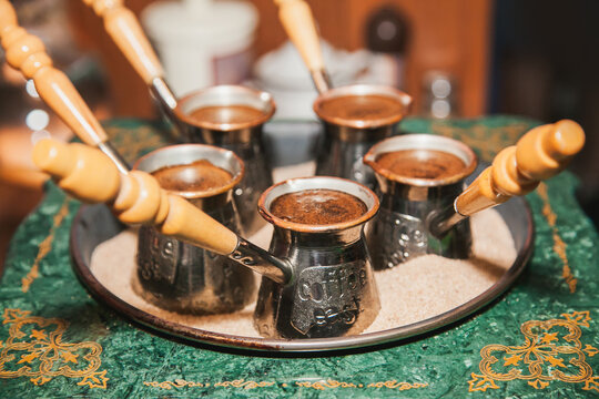Turkish coffee brewed on sand in cezve. Oriental, east coffee