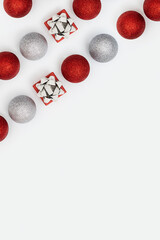 Happy holidays, Merry Christmas, New Year concept. Bright pattern with shiny red and silver Christmas balls and small gift box