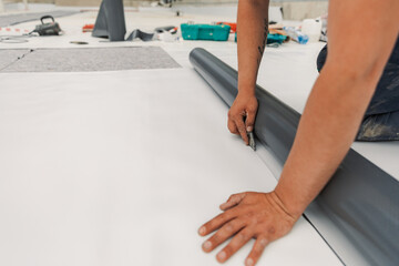 Worker specialized in mounting PVC membranes, TPO in the process of installing a water resistant...