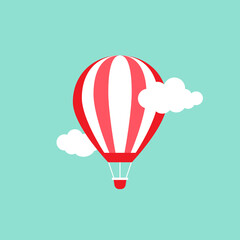 Fototapeta premium Orange hot air balloon flying in the powder blue sky with clouds.