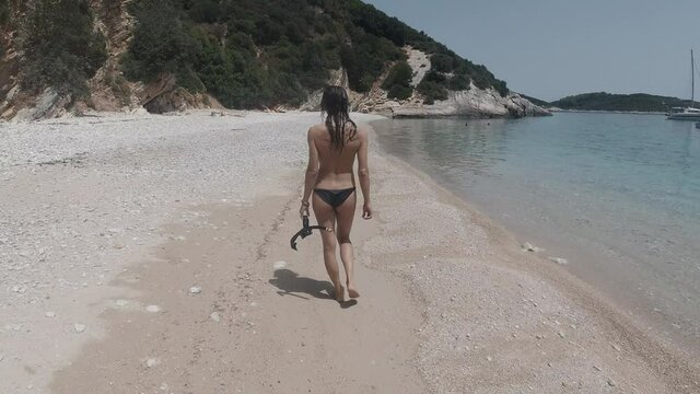 woman walking in the beach, pera pigadhi, lefkada, greece
