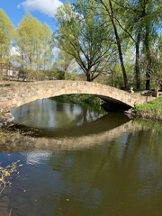 Bridge over a reservoir in the park. Crosswalk across the river. The territory of the castle in Radomyshl, Ukraine
