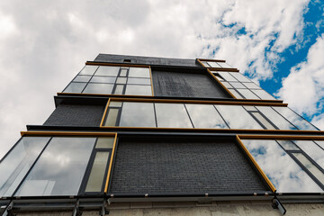 New construction office building with blue sky in the background. Business concept of future architecture,looking up to the light on the top of building