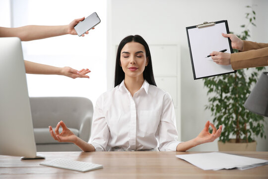 Overwhelmed Woman Meditating At Workplace. Stress Relief Exercise