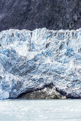 The broken face of the Margerie Glacier in the Tarr Inlet of Glacier Bay, Alaska, USA - Demonstrating erosion of an underlying rock.