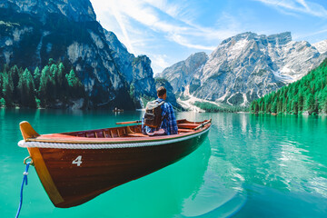 Fototapeta na wymiar man in big wooden boat at mountain lake