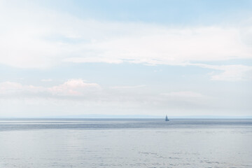 one little sail yacht on sunset at sea bay