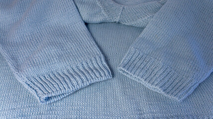 Pullover made of blue wool yarn. Handmade work. Merino wool. Needlework. Handmade work. Hobby.