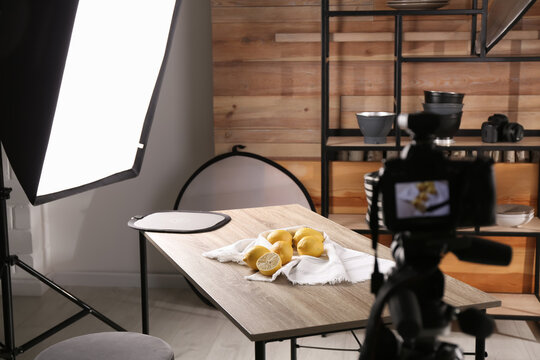Professional equipment and many lemons on table in studio. Food photo