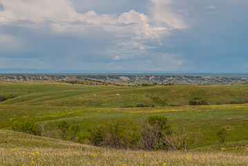 Badlands National Park, SD, USA - June 1, 2008: Wide green landscape with prairie hills and...