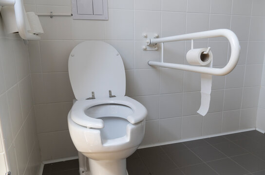 Bathroom Equipped With Toilet For The Elderly And Disabled People With Fall Prevention Handle.
