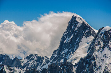 Close-up of snowy peaks and mountains, viewed from the Aiguille du Midi, near Chamonix. A famous ski resort located in the French Alps.