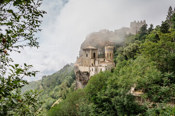 Fototapeta premium Erice,Sicily,Italy.Historic town on the top of mountains overlooking beautiful lush countryside.View of Venus Castle,Castello di Venere, in clouds.Breathtaking panorama.Misty landscape copy space