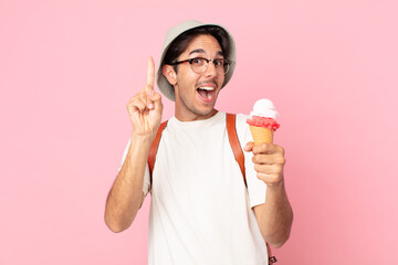 young hispanic man feeling like a happy and excited genius after realizing an idea and holding an...