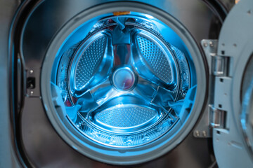 Washing machine laundry home appliance closeup of inside drum.
