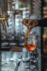 Bartender making aperol spritz summer cocktail in big wine glass