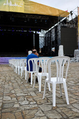 Man sitting on a chair in an empty auditorium