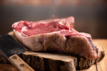 big piece of fiorentina meat on top a wooden table