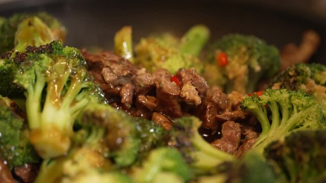 Cooking beef broccoli over a stove
