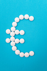 Global Pharmaceutical Industry and Medicine Business - Euro Symbol Made from White Pills Lying on Blue Background