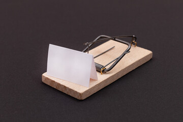 Blank White Sheet of Paper in Wooden Mousetrap - Template. Small Memo Paper in Mouse Trap on Black...