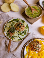 French-style potato salad and chicken cutlets on a light wooden table