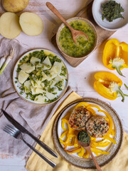 French-style potato salad and chicken cutlets on a light wooden table