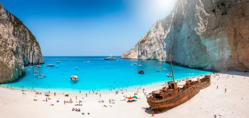 Washable wall murals Navagio Beach,  Zakynthos, Greece Panoramic view of the famous Navagio shipwreck beach on Zakynthos island, Greece, with people enjoying the light blue colored sea