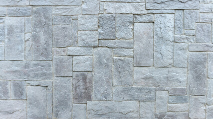 stone wall made of granite blocks of different sizes as the background