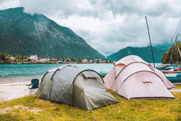 Camping tents on the coast of the alpine lake in Bavaria, Germany. Outdoor vacation in the...