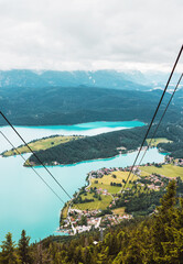 Panoramic mountain view from the cable car. Alpine turquoise lake and small village in Bavaria,...