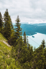 Panoramic mountain view. Alpine turquoise lake with island, spruce forest in Bavaria, Germany. From...