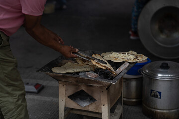 person cooking quesadillas
