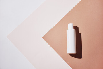 Natural cosmetics mock up. Beauty product concept. White bottle on pastel background