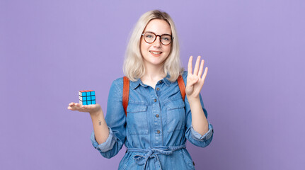 young pretty albino woman smiling and looking friendly, showing number four and solving an...