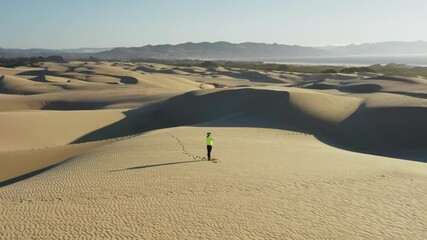 Woman performing spiritual yoga pose on top of sand dune desert at sunrise in VR - Powered by Adobe